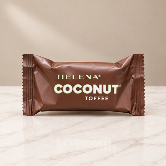Helena Coconut Toffee in its individual brown wrapper on white marble.