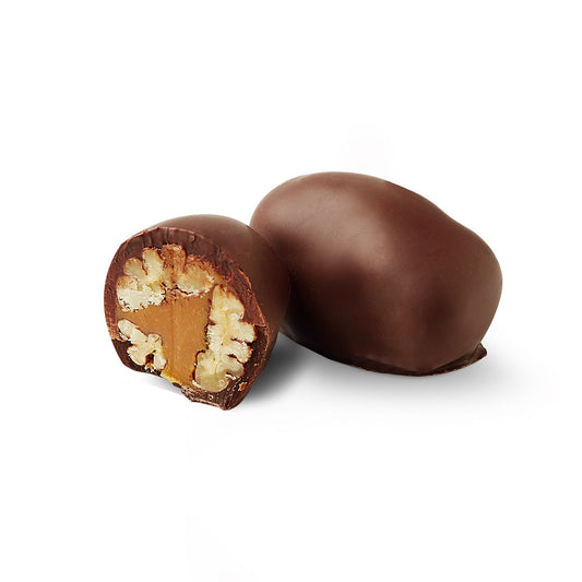 Pecan chocoteja bonbon cut in half showing dulce de leche filling