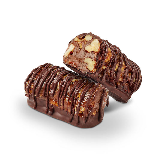Pecanroll toffee bar cut in half showing pecan and toffee layers