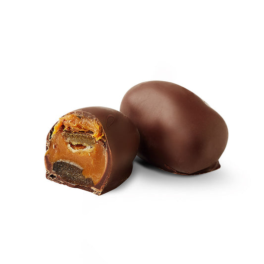 Orange chocoteja bonbon cut in half showing dulce de leche filling