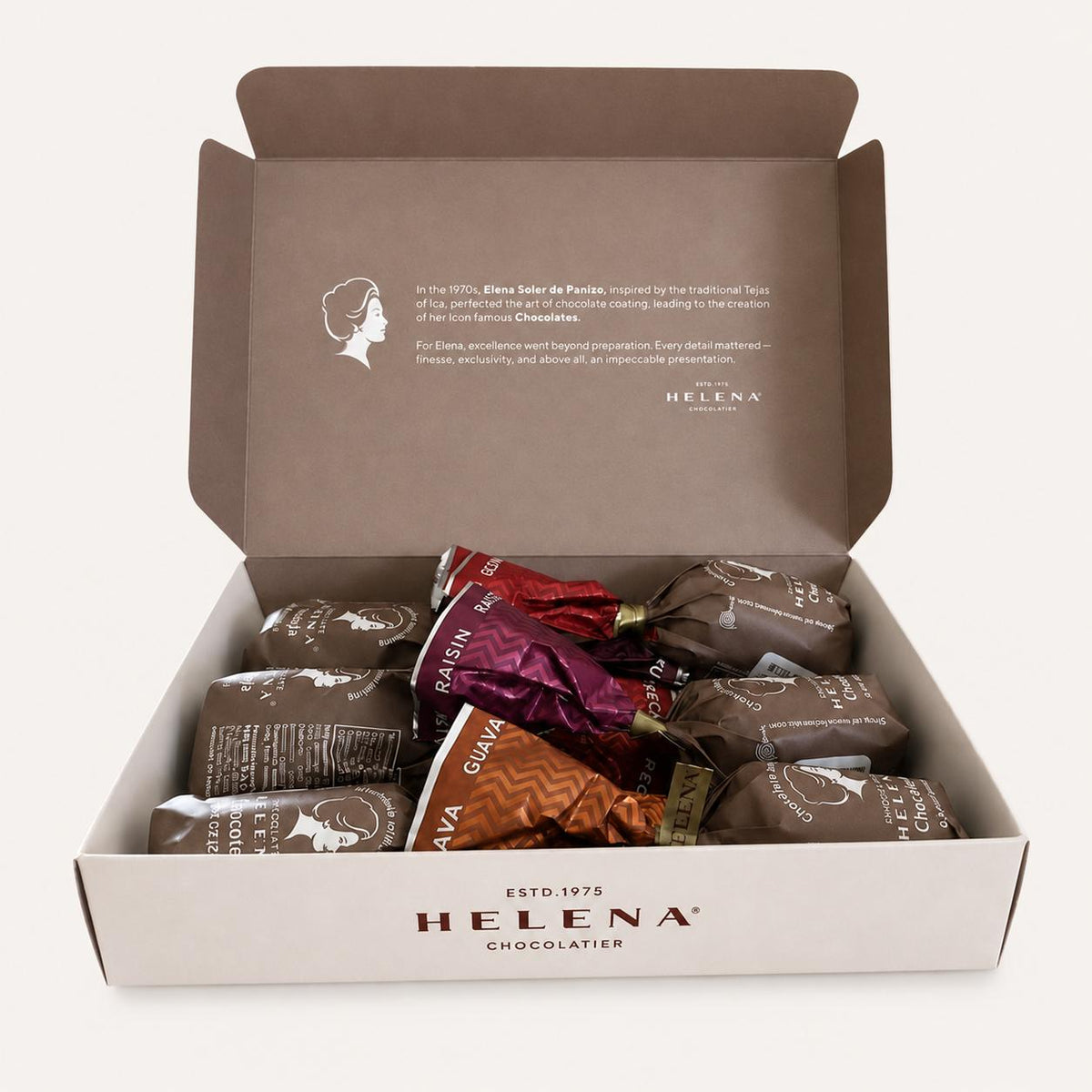 Open Helena Chocolatier gift box with 6 assorted Chocoteja Bonbons in raisin, guava and pecan foil wrappers, white background