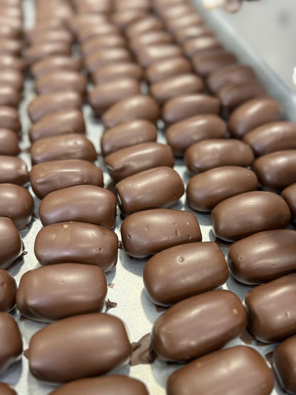 Row of chocoteja bonbons  on a tray at the factory